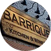 Detalle circular de letrero 'Barrique Kitchen & Wine'.