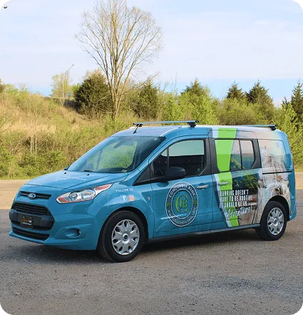 Proyecto 5: van de servicio azul con gráficos verdes de fleet graphics.